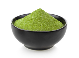 instant matcha green tea inblack bowl on white