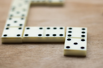  The game of dominoes. Pieces of dominoes on a brown wooden table background
