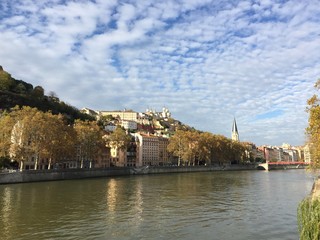 The Saint-Georges Roman Catholic church, the Paul Couturier bridge and the quays of the Saône river in Lyon, France. In the background the Basilica of Notre-Dame de Fourvière