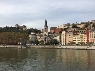 Fototapeta na wymiar The Saint-Georges Roman Catholic church, the Paul Couturier bridge and quays of the Saône river in Lyon, France 
