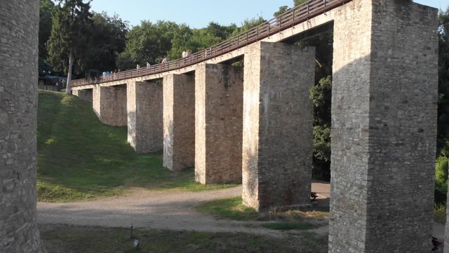 Cetatea Neamt. Neamt Citadel, Neamt County, Romania. Aerial Footage of medieval fortress surrounded by forest! Fly under suspended high bridge
