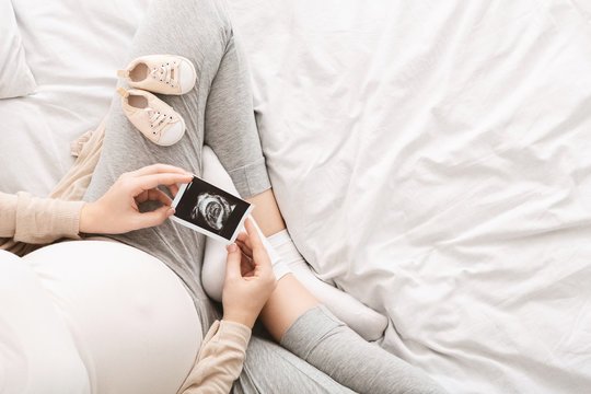 Pregnant woman enjoying her baby ultrasound photo