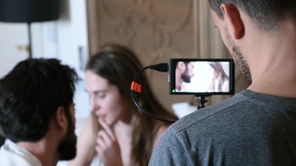 Behind the scenes of a film a young couple having a serious breakup talk in bed. 4K