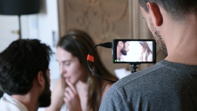 Behind the scenes of a film a young couple having a serious breakup talk in bed. 4K