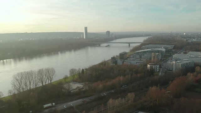 Panorama drone / aerial shot of Bonn and the river rhine with the post tower, the kameha hotel and a ship at the afternoon, 24p