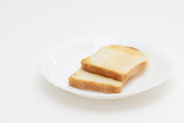 Toasted toasts on a white plate. Breakfast is delicious and healthy.