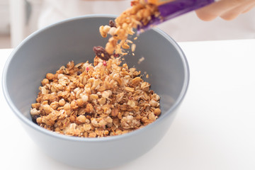 Delicious granola is poured into a breakfast plate