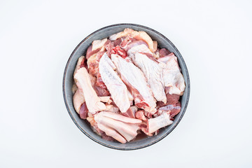 Freshly chopped duck meat on a saucer on white background