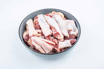 Freshly chopped duck meat on a saucer on white background