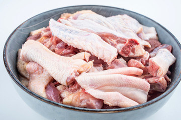Freshly chopped duck meat on a saucer on white background