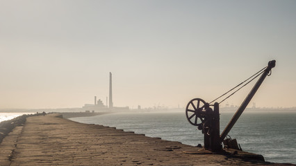 View from the Great South Wall in Dublin Bay, Ireland. The towers of Poolbeg power station and the Port of Dublin can be seen in the distance.