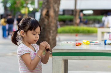 Hearing impaired children playing on the table in the park.