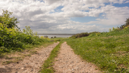 Walking trail at Red Rock, Sutton, County Dublin on the east coast of Ireland. A martello Tower and Dublin Bay can be seen in the distance.