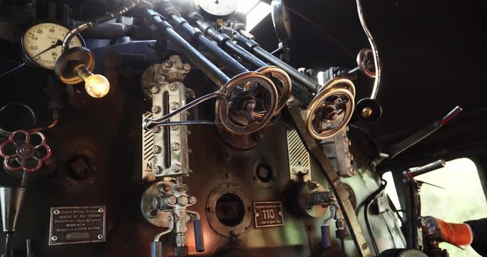 Close shot inside steam train locomotive, train driver control gears