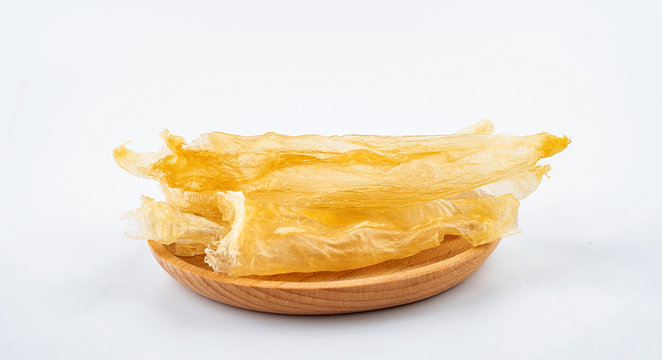 Tonic Food Maw Catfish Gum on a saucer on white background