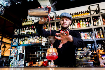 Bartender is making cocktail at bar counter. Fresh cocktails. 