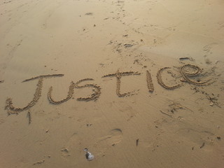 Justice written on the beach 