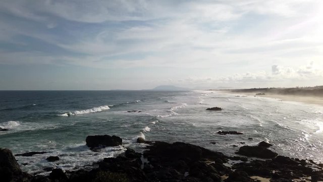 Panoramic view of long ocean beach at sunset artistic reflection