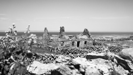 Black and white shot of a ruined, abandoned cottage on Inishmaan (Inis Meain), one of the Aran Islands off the coast of Galway in the west of Ireland.