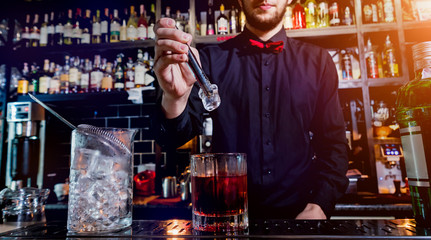 Bartender is making cocktail at bar counter. Fresh cocktails. 
