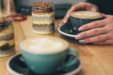 Close up of female hands holding coffee mug