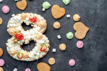 number plate cake of 8 decorated with flowers, cream of cheese, marshmallows, Bizet on a stone background. postcard International Women's Day March 8