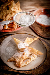 Faworki decorated with powdered sugar.