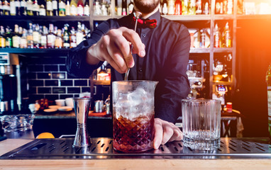 Bartender is making cocktail at bar counter. Fresh cocktails. 