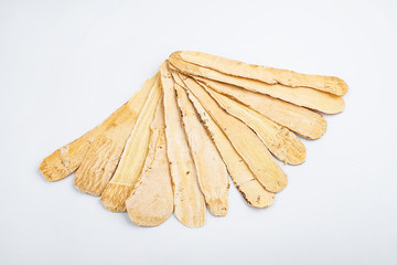 Astragalus medicinal herbs on white background