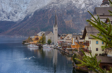 Hallstatt, a charming village on the Hallstattersee lake and a famous tourist attraction, with beautiful mountains surrounding it, in Salzkammergut region, Austria, in winter sunny day.
