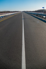 Fototapeta premium marking on the road the white stripe goes into the distance to the point