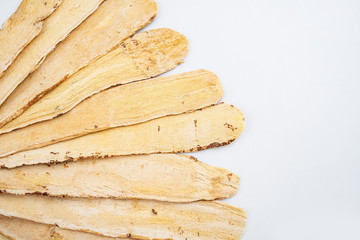 Astragalus medicinal herbs on white background