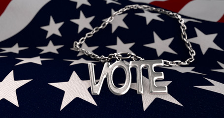 3 D Illustration Of A Necklace With The Word Vote Lying Atop The Uninted States Flag.