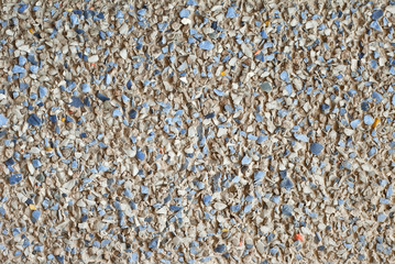 The texture of the wall is made of small blue and white stones.