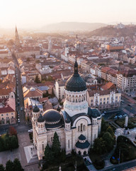 Aerial drone shot of the famous Orthodox Cathedral in Cluj, Romania while sunset