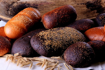 Fresh collection of bread and wheat on the table. Collection of different types of bread: White, rye, seed, form bread. lots of photos of bread with rye ears