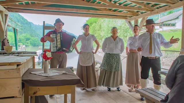 Musicians sing for tourists on Drava Riverboat Muta, Slovenia, slowmo