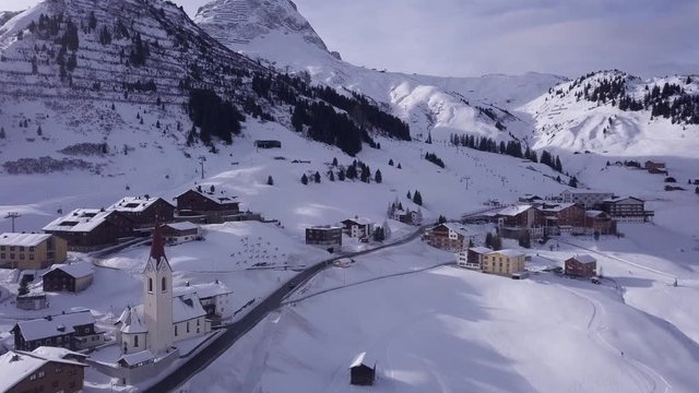 Aerial shot of Warth, an idyllic snowy village high up in the Austrian alps