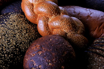 Fresh collection of bread and wheat on the table. Collection of different types of bread: White, rye, seed, form bread. lots of photos of bread with rye ears