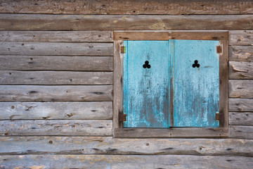 Old blue vintage window in Hallstatt, a charming village on the Hallstattersee lake and a famous tourist attraction, in Salzkammergut region, Austria.