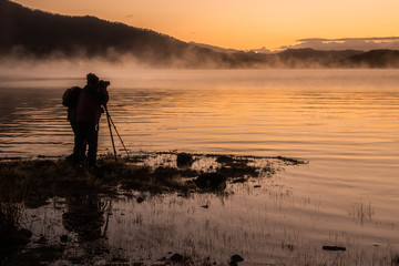 silhouette of fisherman at sunset