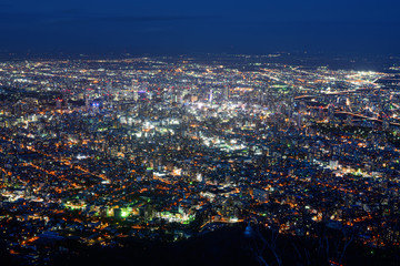 Obraz premium Dazzling night view of Sapporo, Japan with the city center glowing brightly