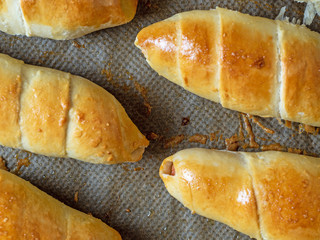 Top view of The finished juicy sausage in the dough. Close-up of flour products