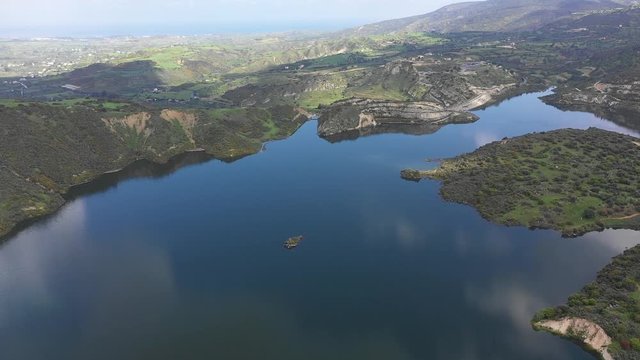 Aerial drone shot over the Evretou Dam flying towards Pafos City, Cyprus.