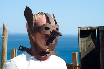 medieval torture mask on blond man