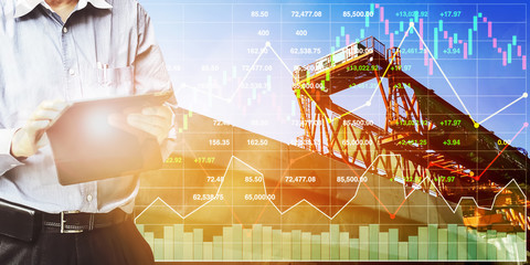 Stock index financial show engineer use tablet to control and operate  on construction industry and real estate business with graph and chart at construction site background.