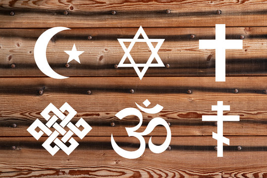 Symbol of different religions on a wooden background
