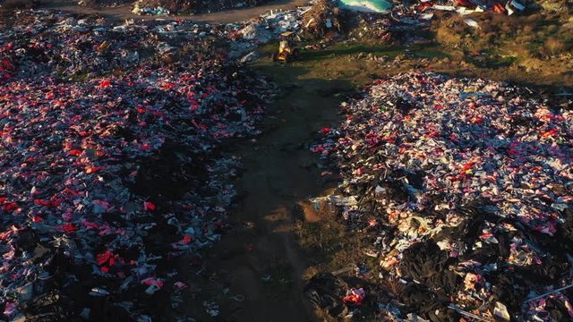 Aerial ascending from refugee lifejacket graveyard Lesvos
