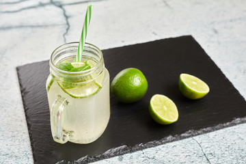 Lemonade with lemons on a slate board..Summer drink. Lemon fresh.