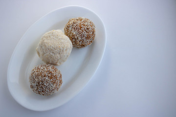 Arrangement of coconut cookies on blue background.